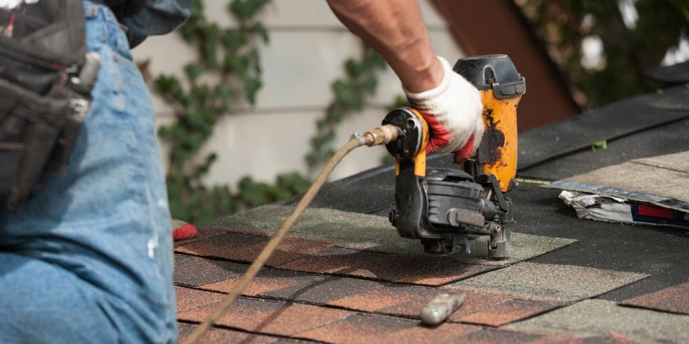 Roofing contractor installing a new roof.