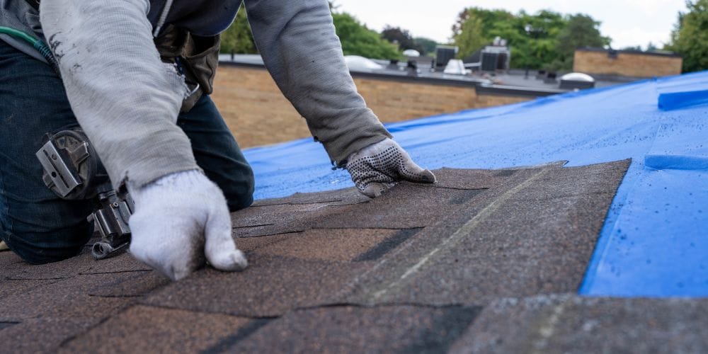 Construction worker installing a new roof.